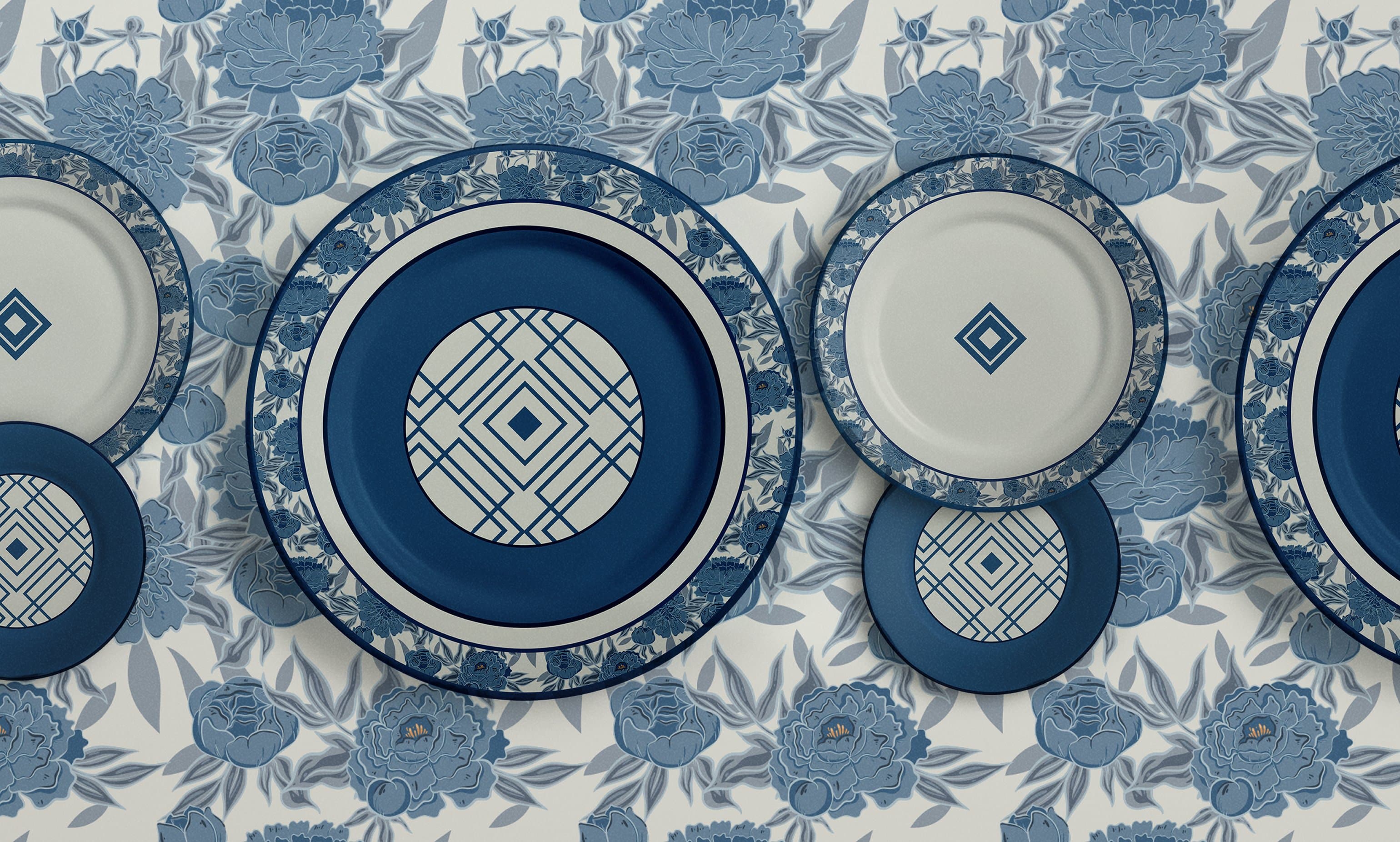 Amber Shockey & Co. blue florals collection, plates layered on peony pattern background, stacked to read as a still life