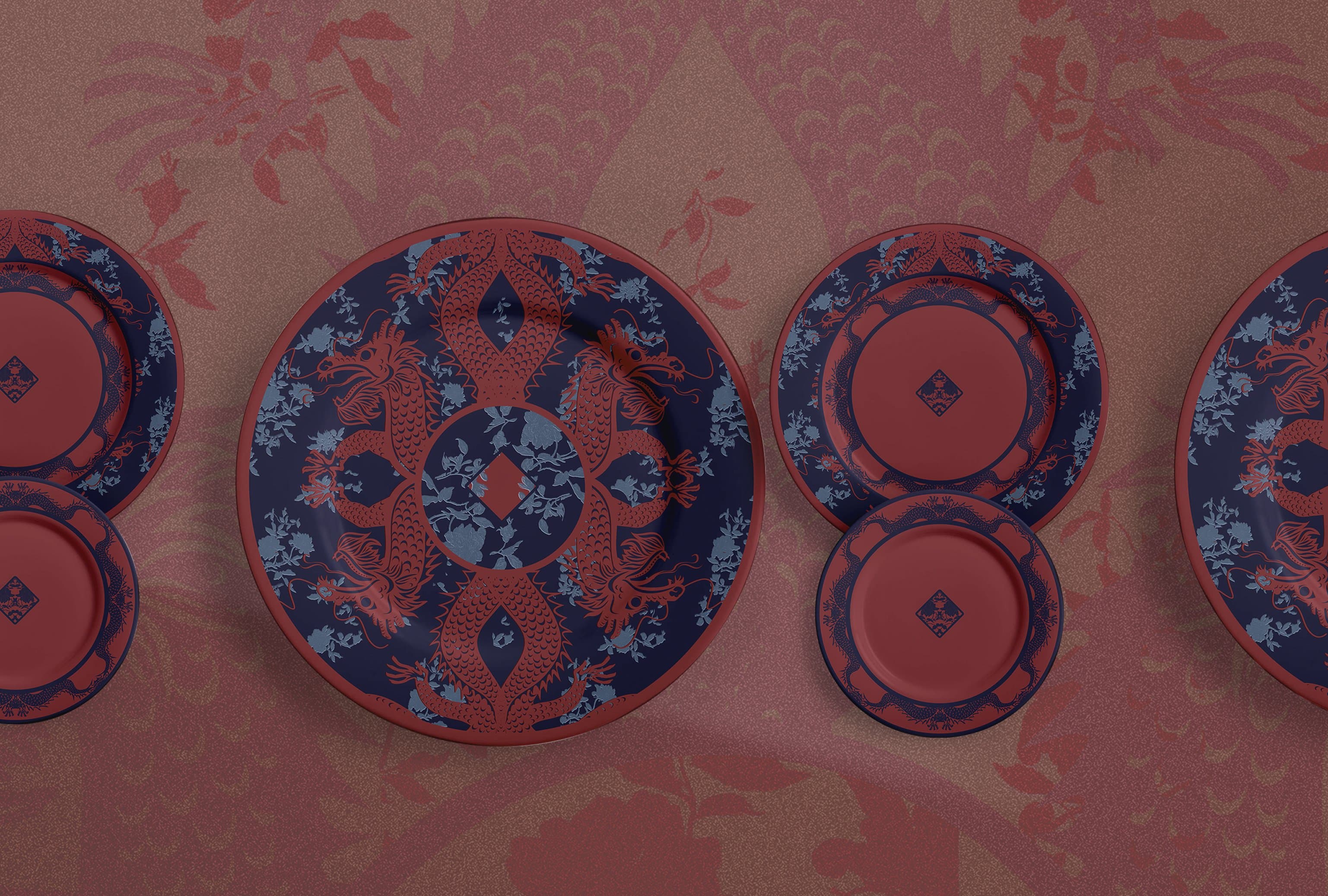 Red dragons collection, plates set against dragon pattern backdrop in burgundy and rose