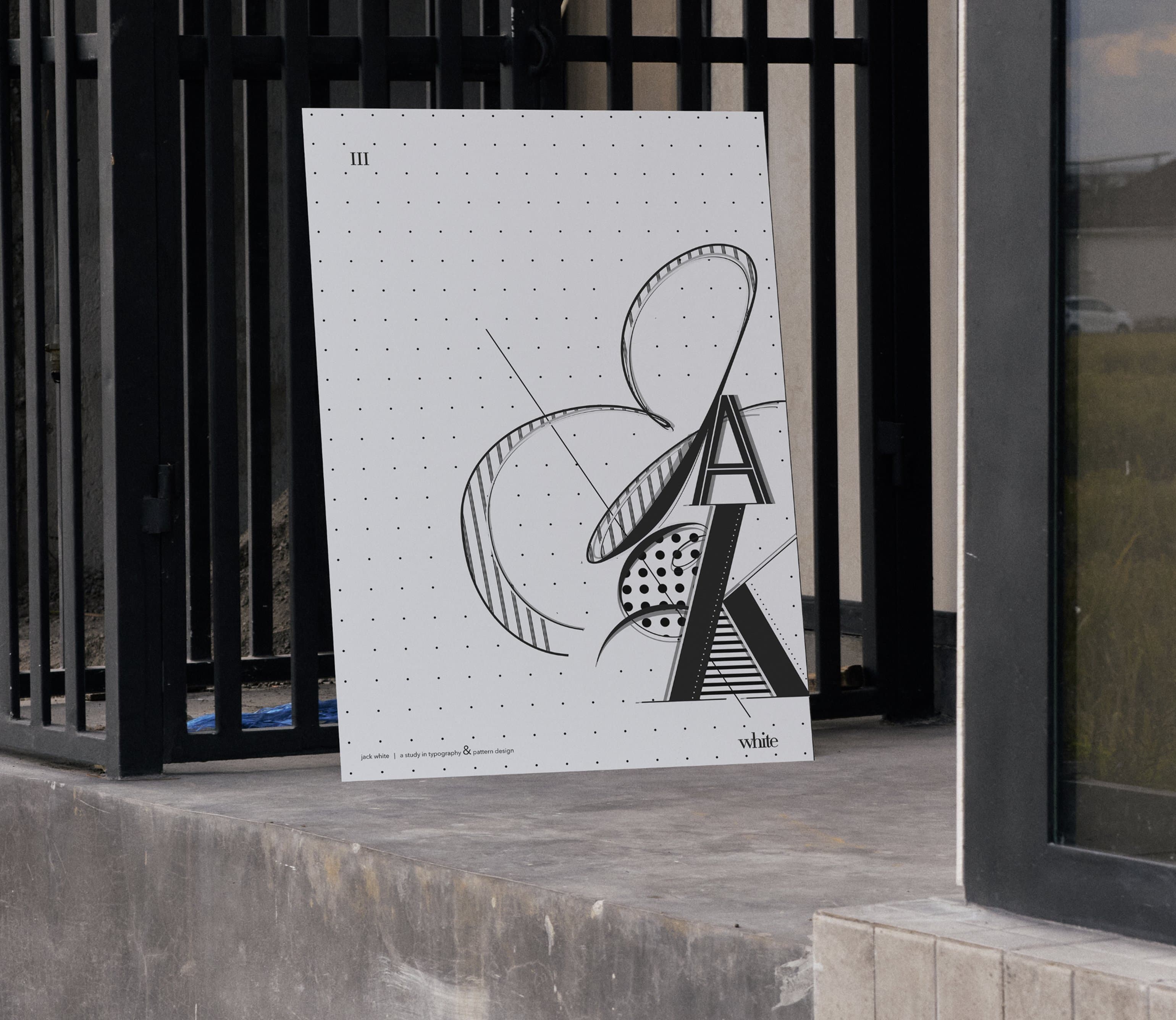 Typography & Patterns, white art print leaning against metal gate outdoors