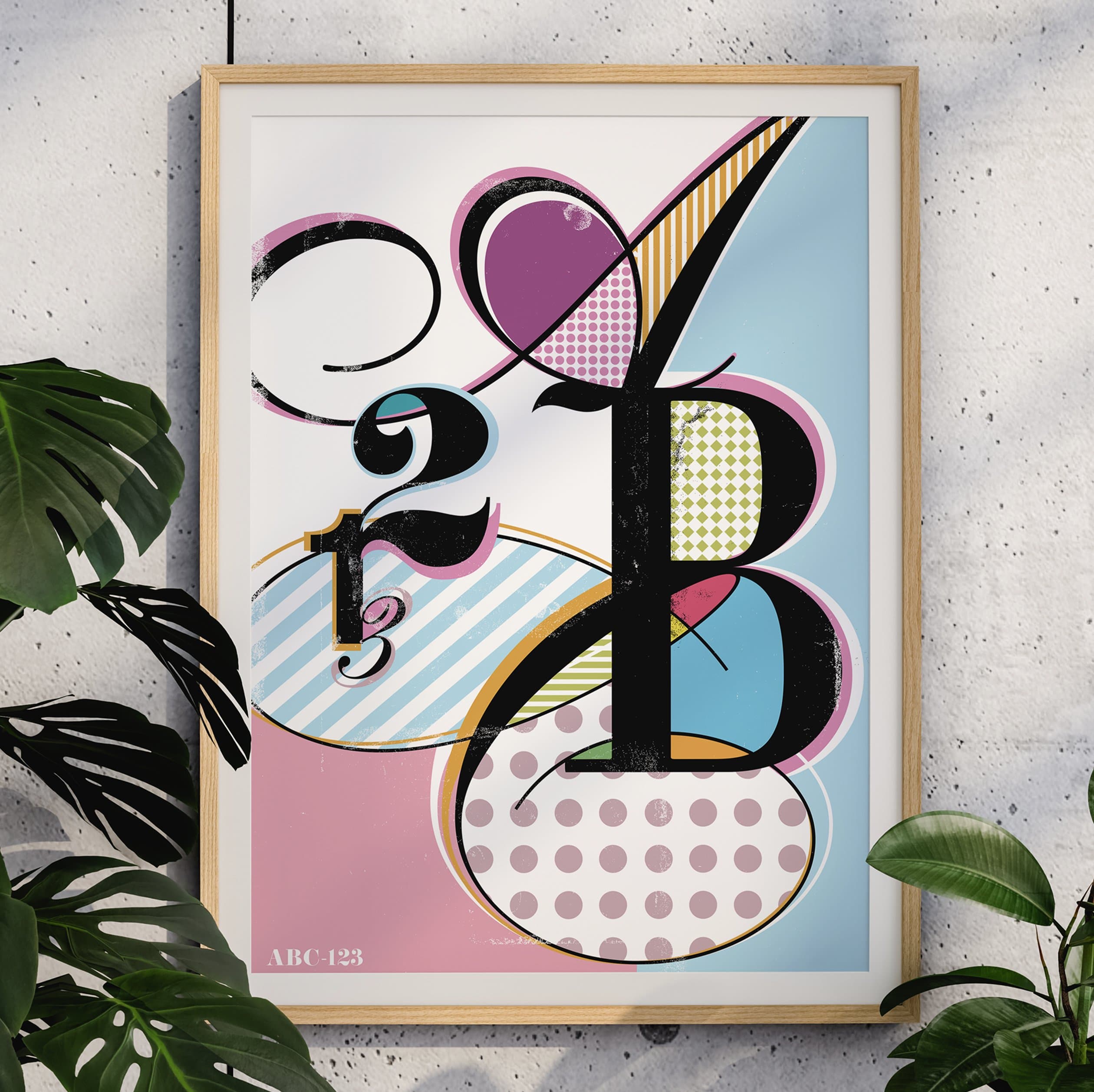 ABC 123 typography poster with patterned letterforms in pink, blue, and yellow, framed on speckled wall with monstera leaves