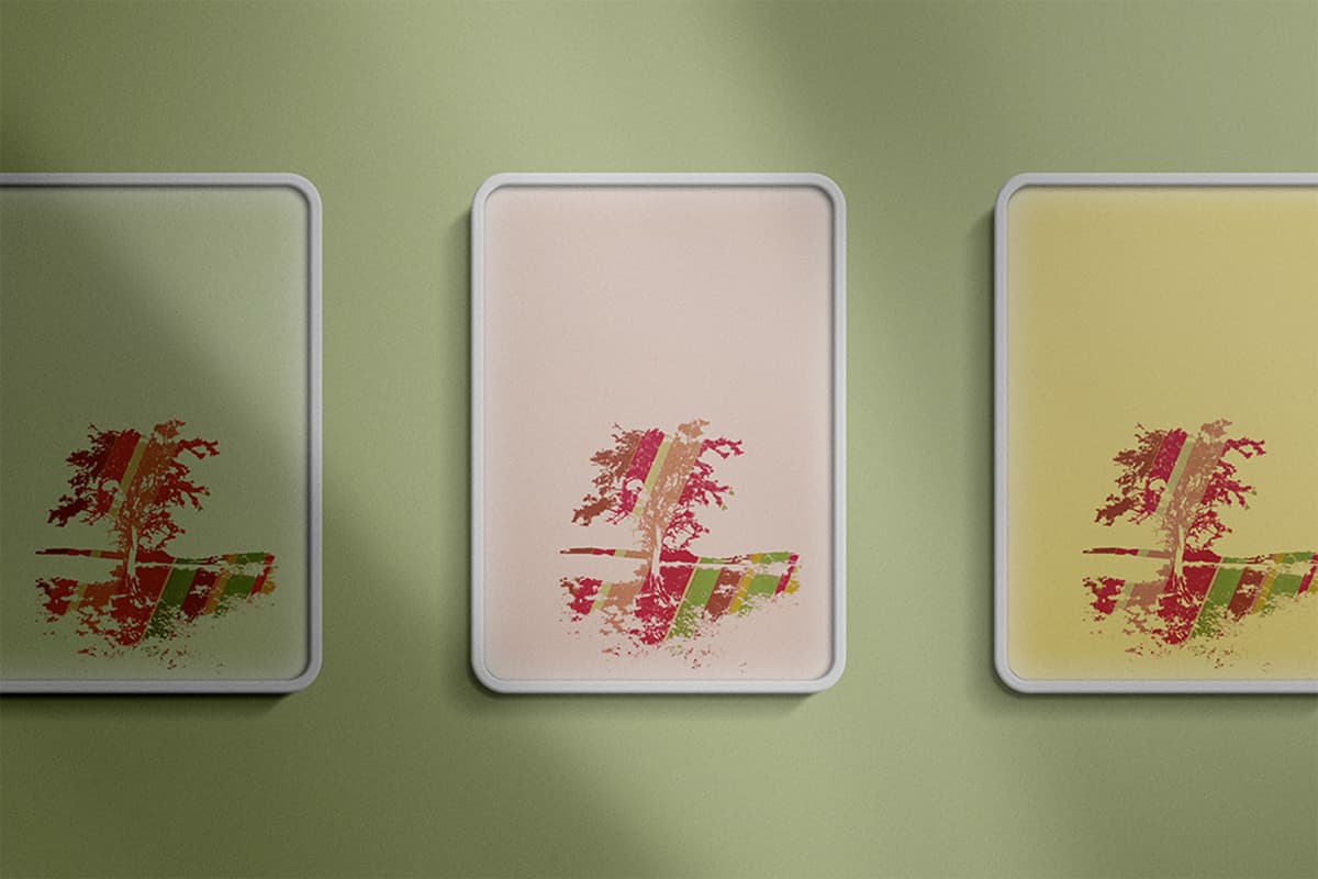 Tree silhouette print color study, three framed prints on green wall
