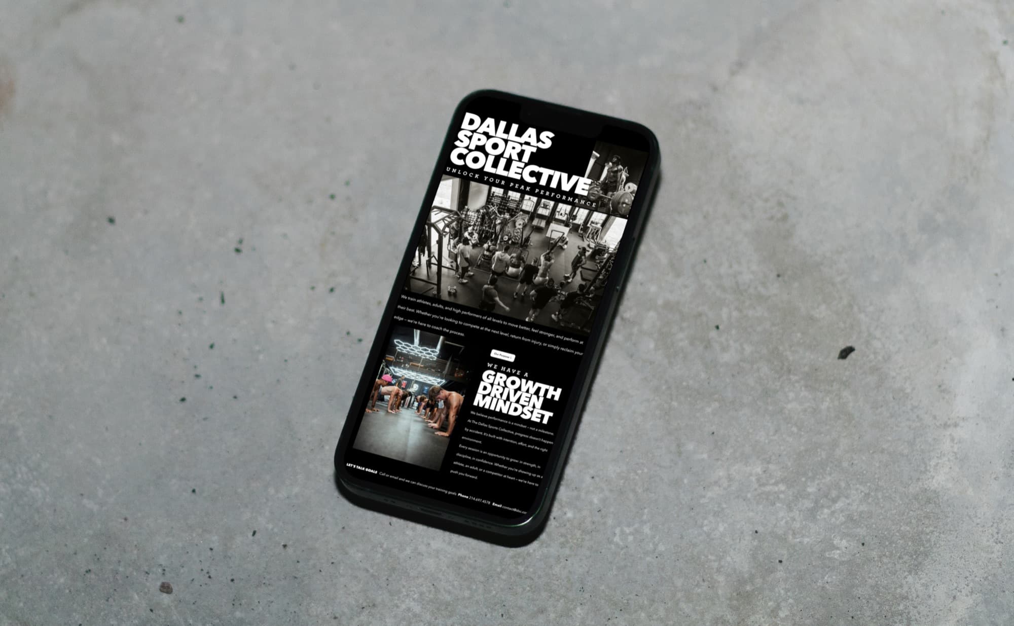 The DSC marketing site open on a phone, resting on concrete