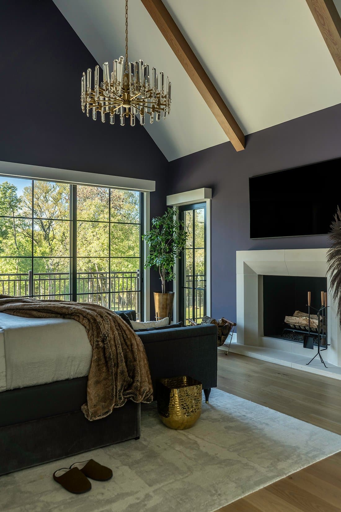 Primary suite, chandelier, cast stone fireplace, faux fur throw, leather slippers