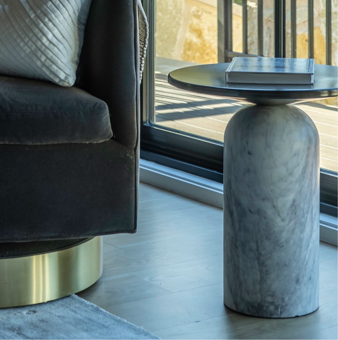 Marble pedestal side table, brass swivel chair base, charcoal velvet upholstery