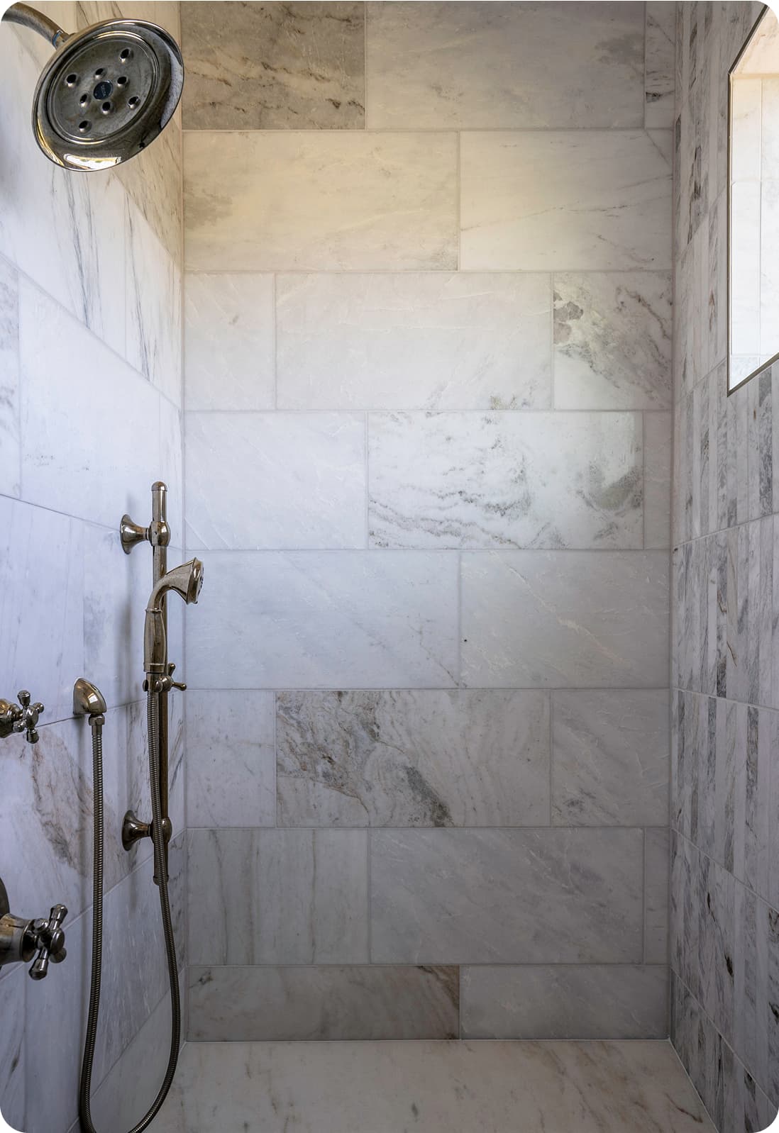 Marble shower, rain head and hand shower, polished nickel fixtures, large format marble tile