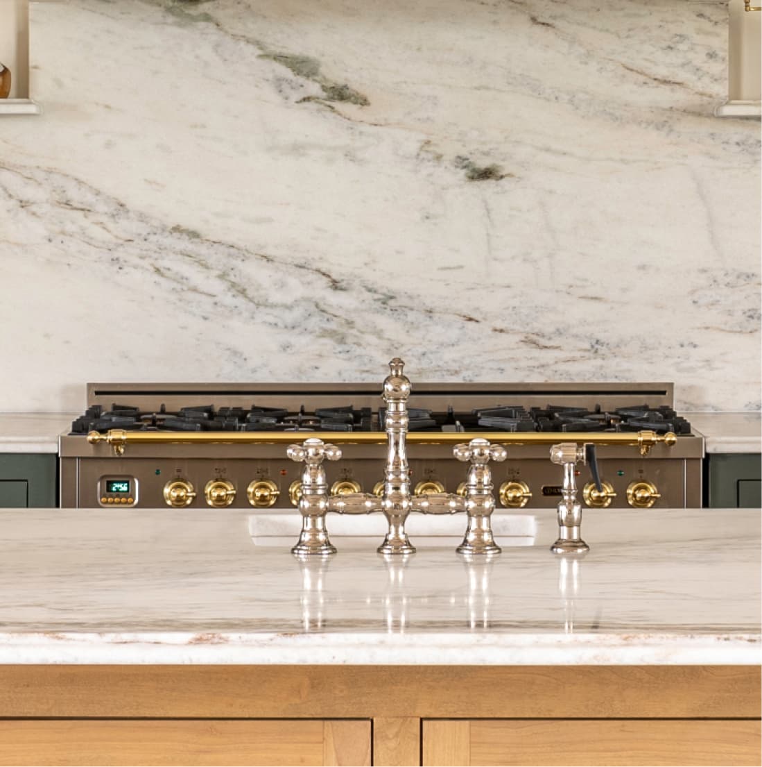 Bridge faucet and range detail, marble island countertop