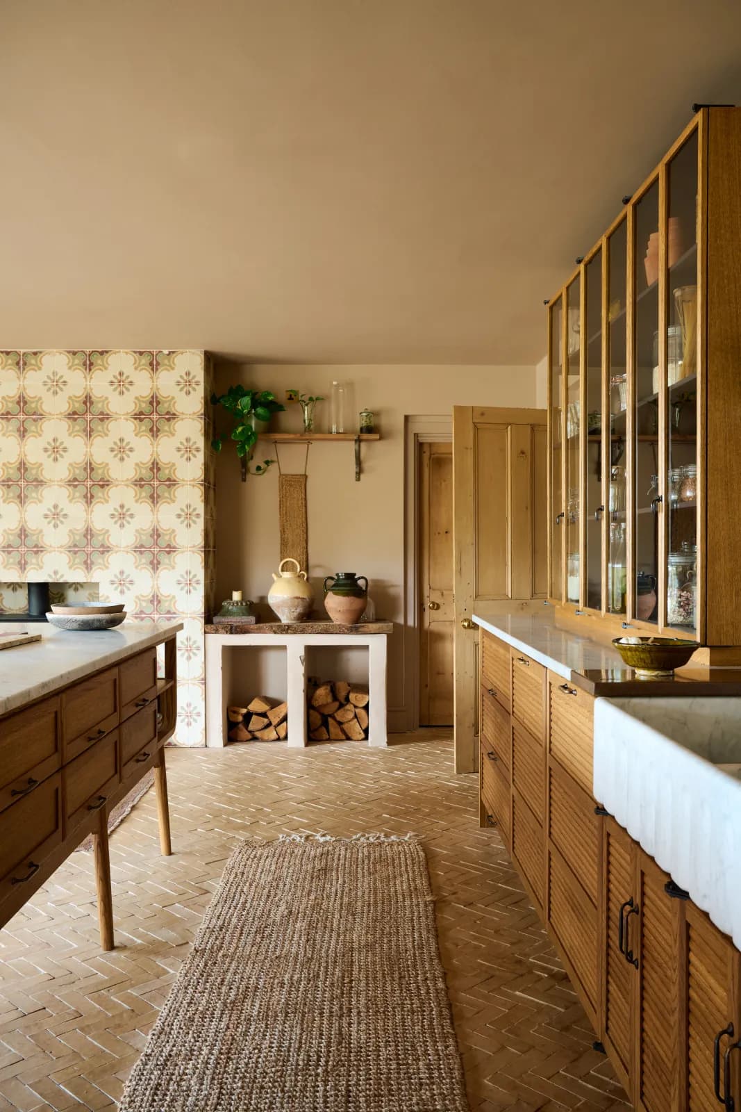 Bert and May kitchen with patterned tile backsplash and oak cabinetry