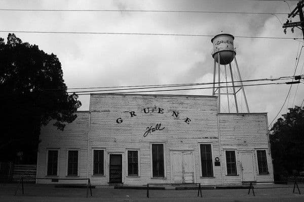 Black-and-white shot of Gruene Hall dance hall with water tower behind