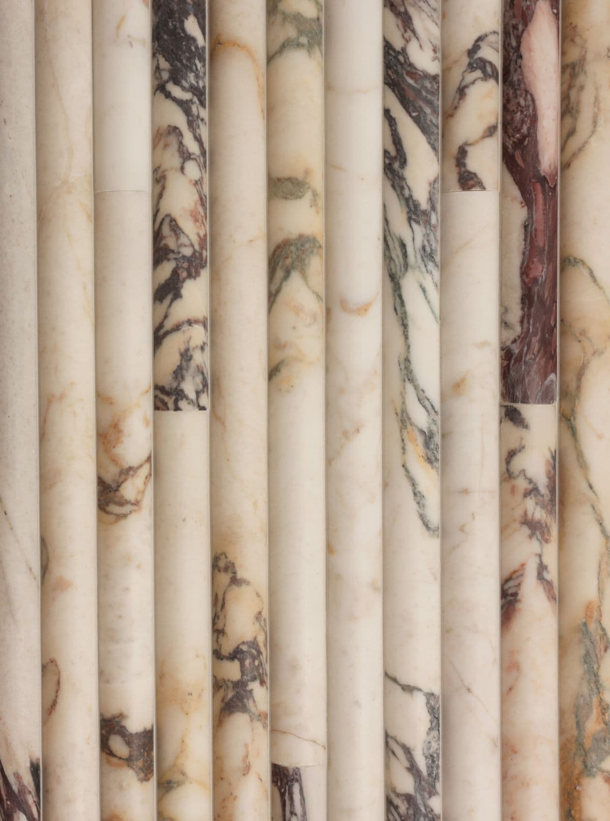 Calacatta viola marble fluted columns in cream and burgundy veining