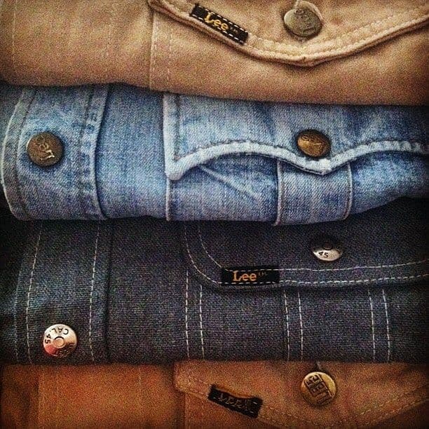 Stack of vintage Lee denim and corduroy shirts showing button and label detail