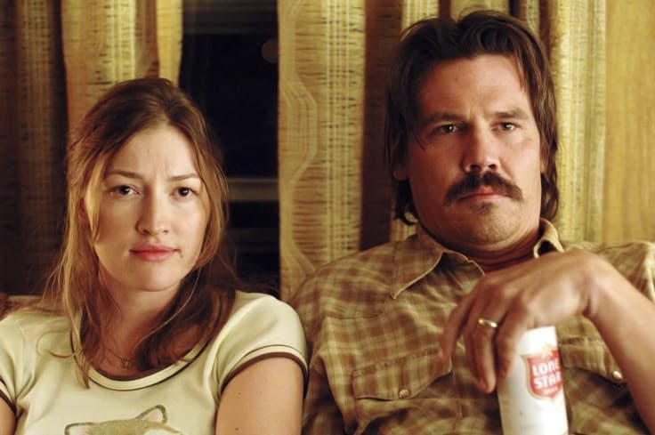No Country for Old Men film still, couple seated on a trailer couch with Lone Star beer