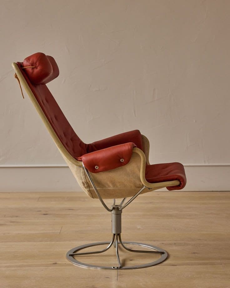 Red leather Bruno Mathsson Jetson swivel chair on wood floor