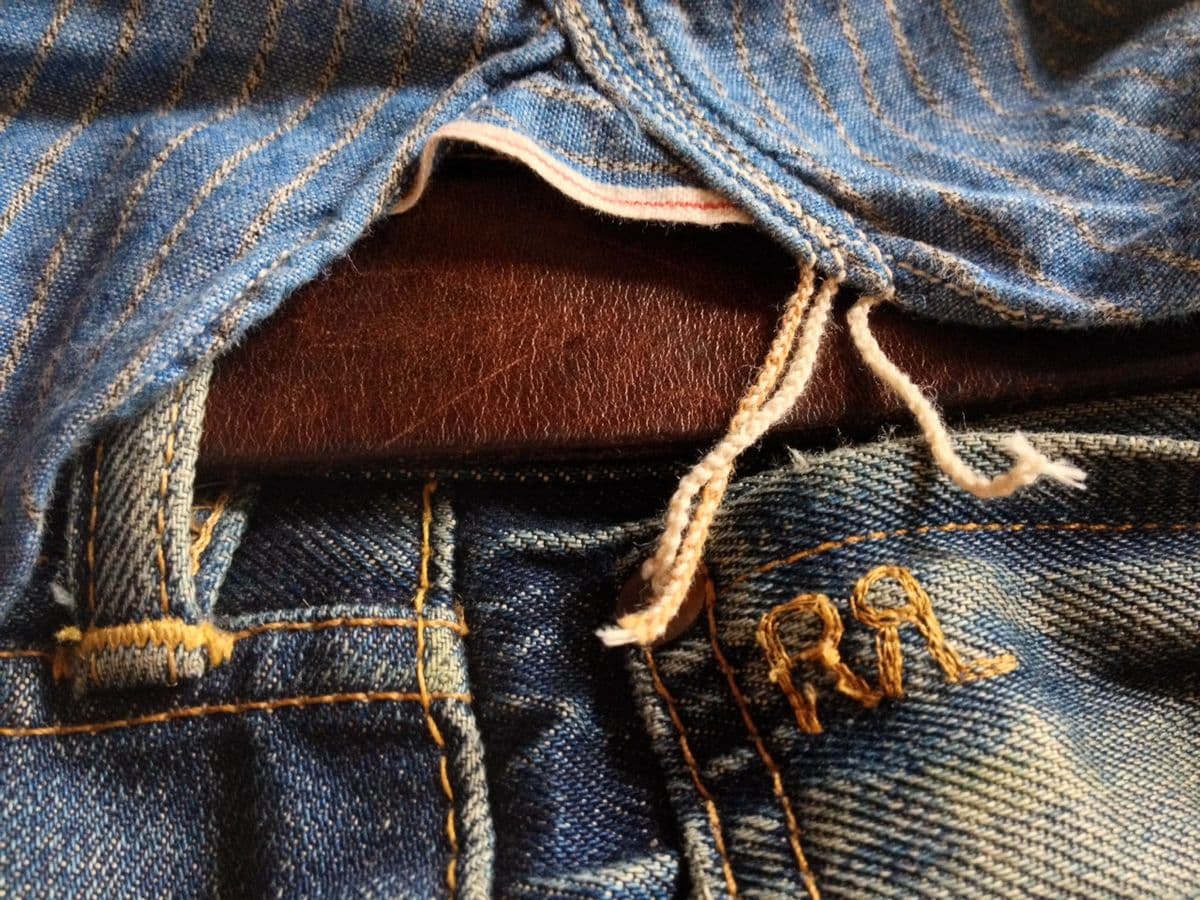 Close-up of vintage RRL denim with leather inset and rope-tied detail