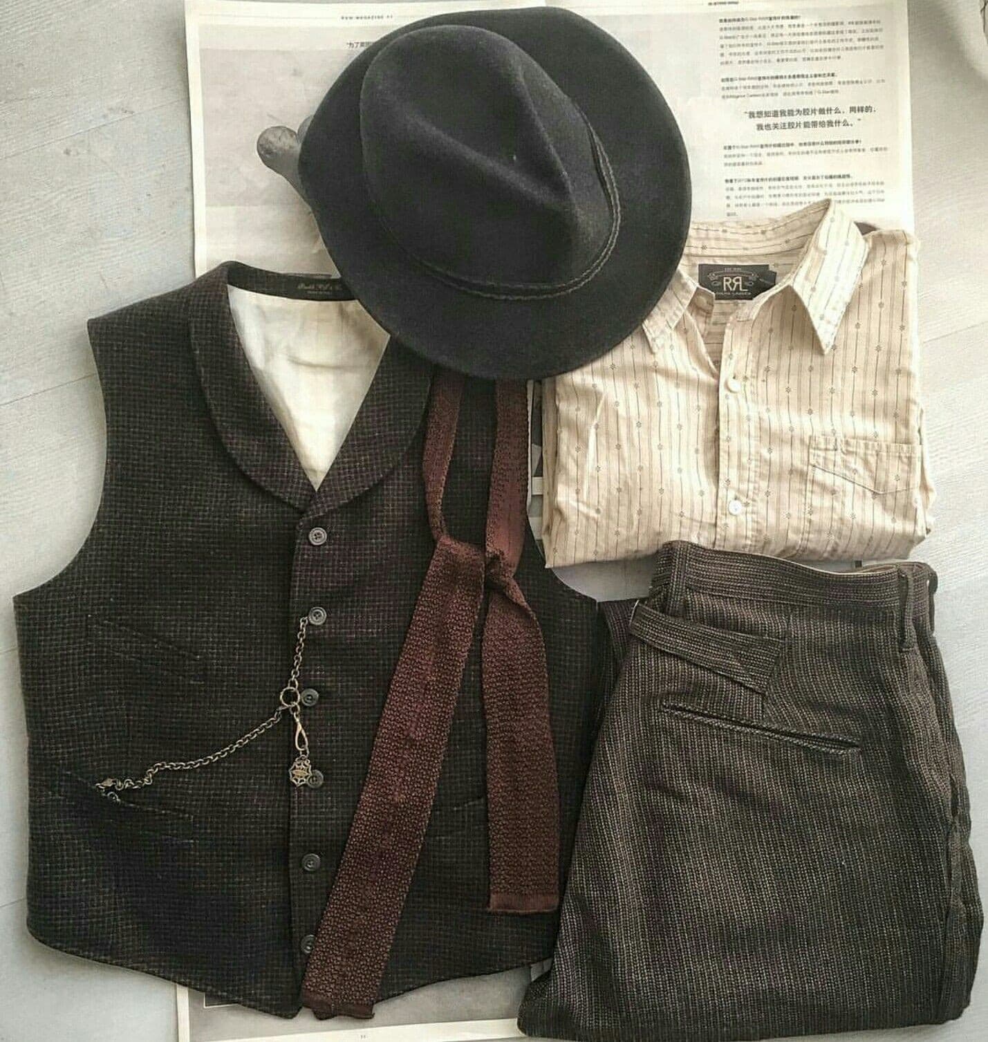 Flat lay of vintage tweed vest, dark fedora, knit tie, and RRL striped shirt