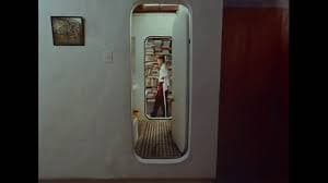 Wes Anderson film still, narrow doorway framing a small interior scene