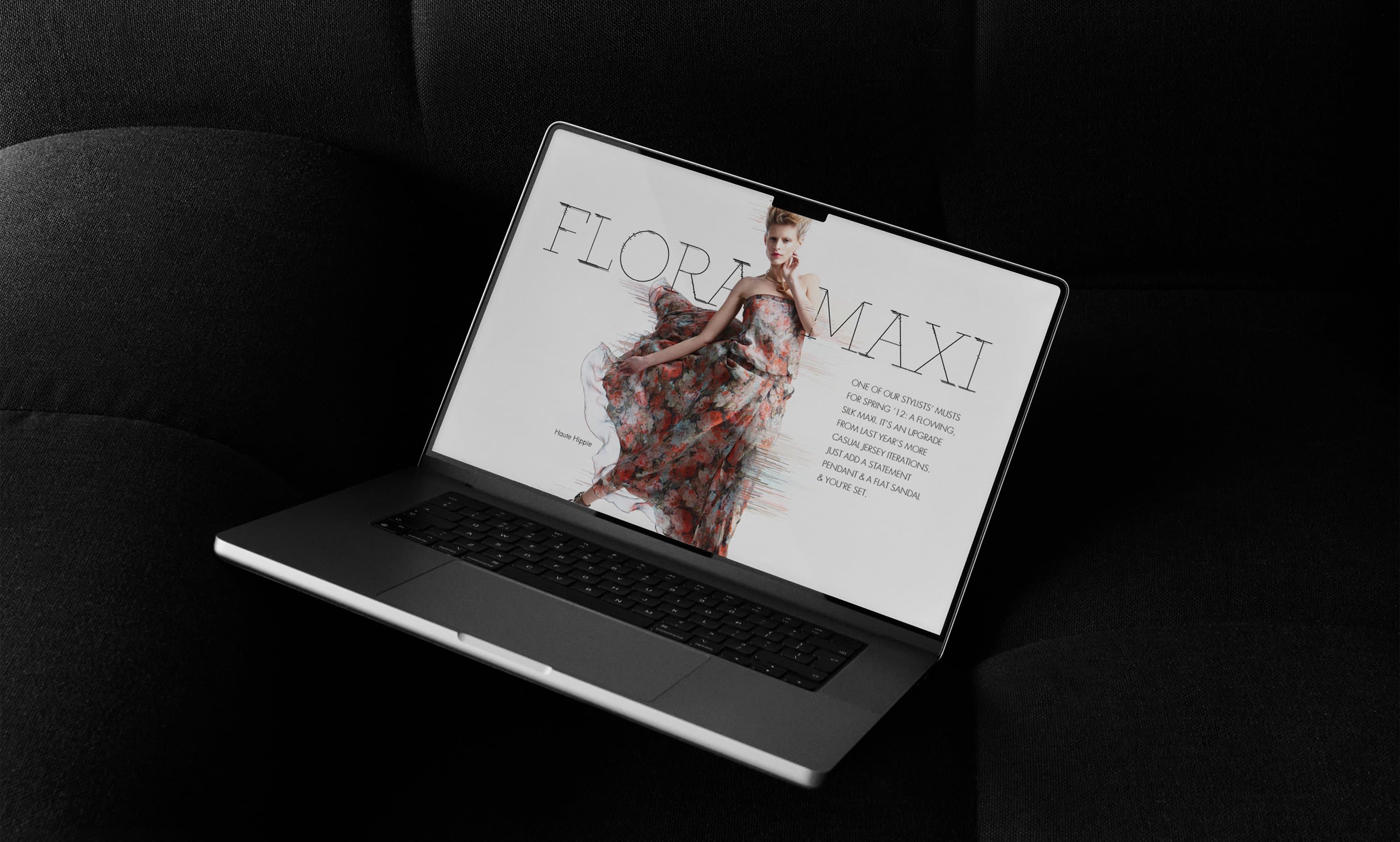 Neiman Marcus InSite Flora Maxi story on laptop resting on black couch