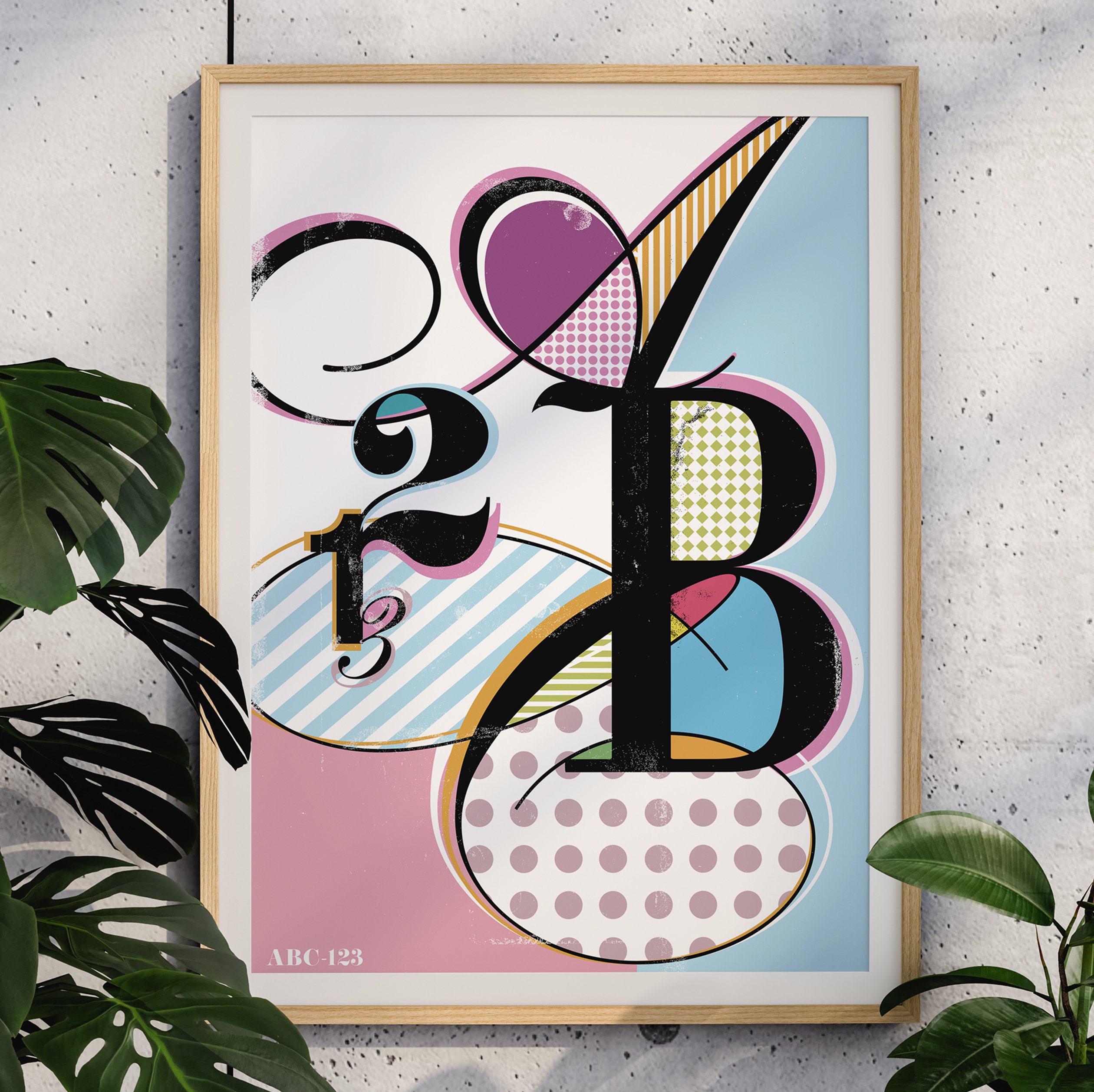 ABC 123 typography poster with patterned letterforms in pink, blue, and yellow, framed on speckled wall with monstera leaves