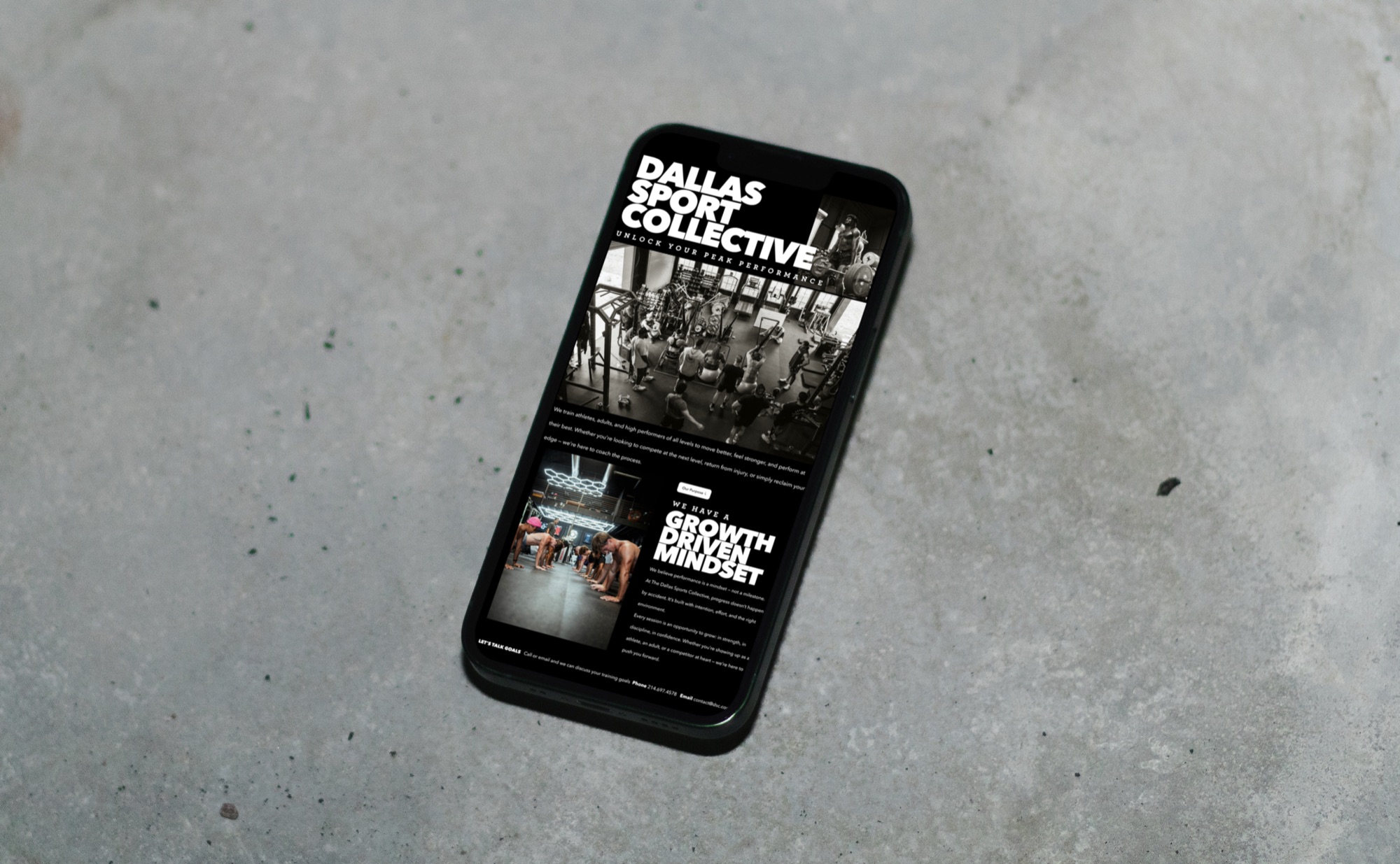 The DSC marketing site open on a phone, resting on concrete
