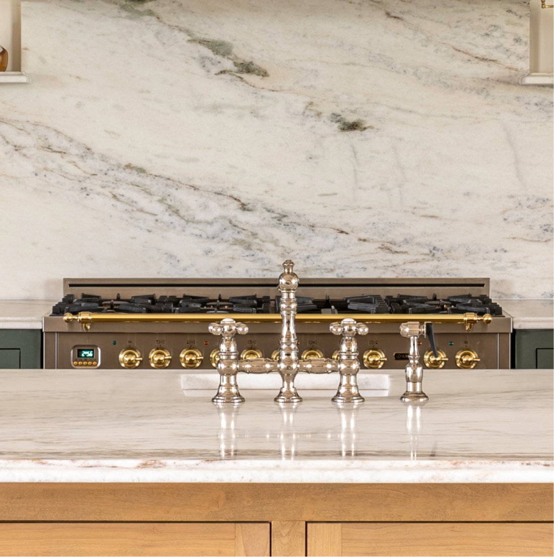 Bridge faucet and range detail, marble island countertop