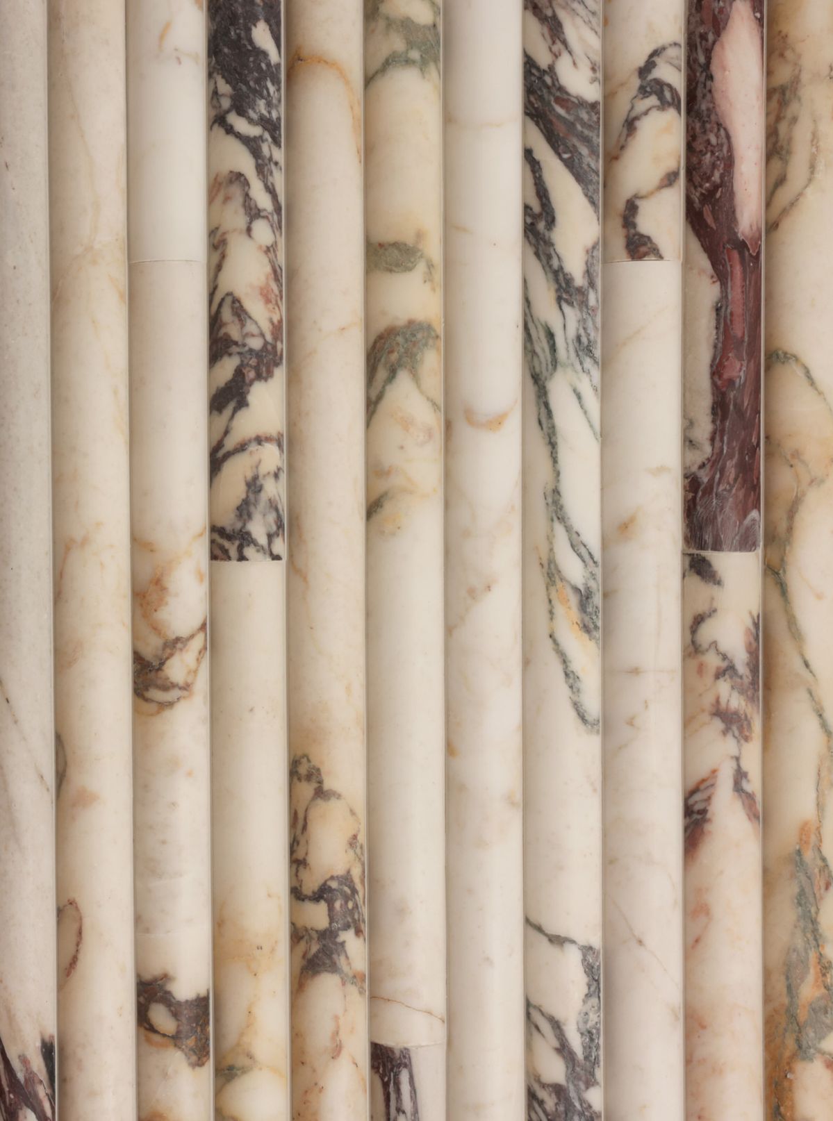 Calacatta viola marble fluted columns in cream and burgundy veining