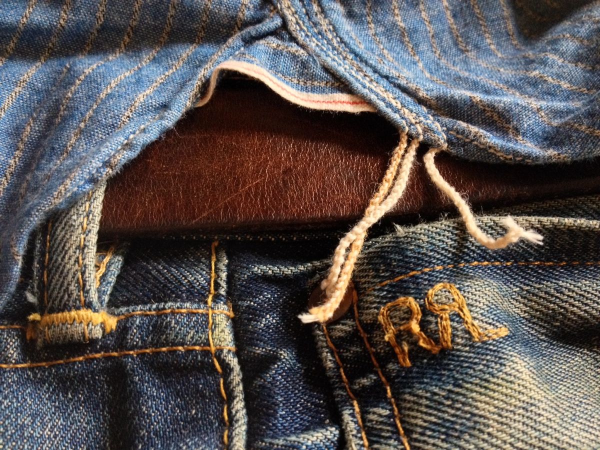 Close-up of vintage RRL denim with leather inset and rope-tied detail