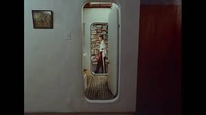 Wes Anderson film still, narrow doorway framing a small interior scene