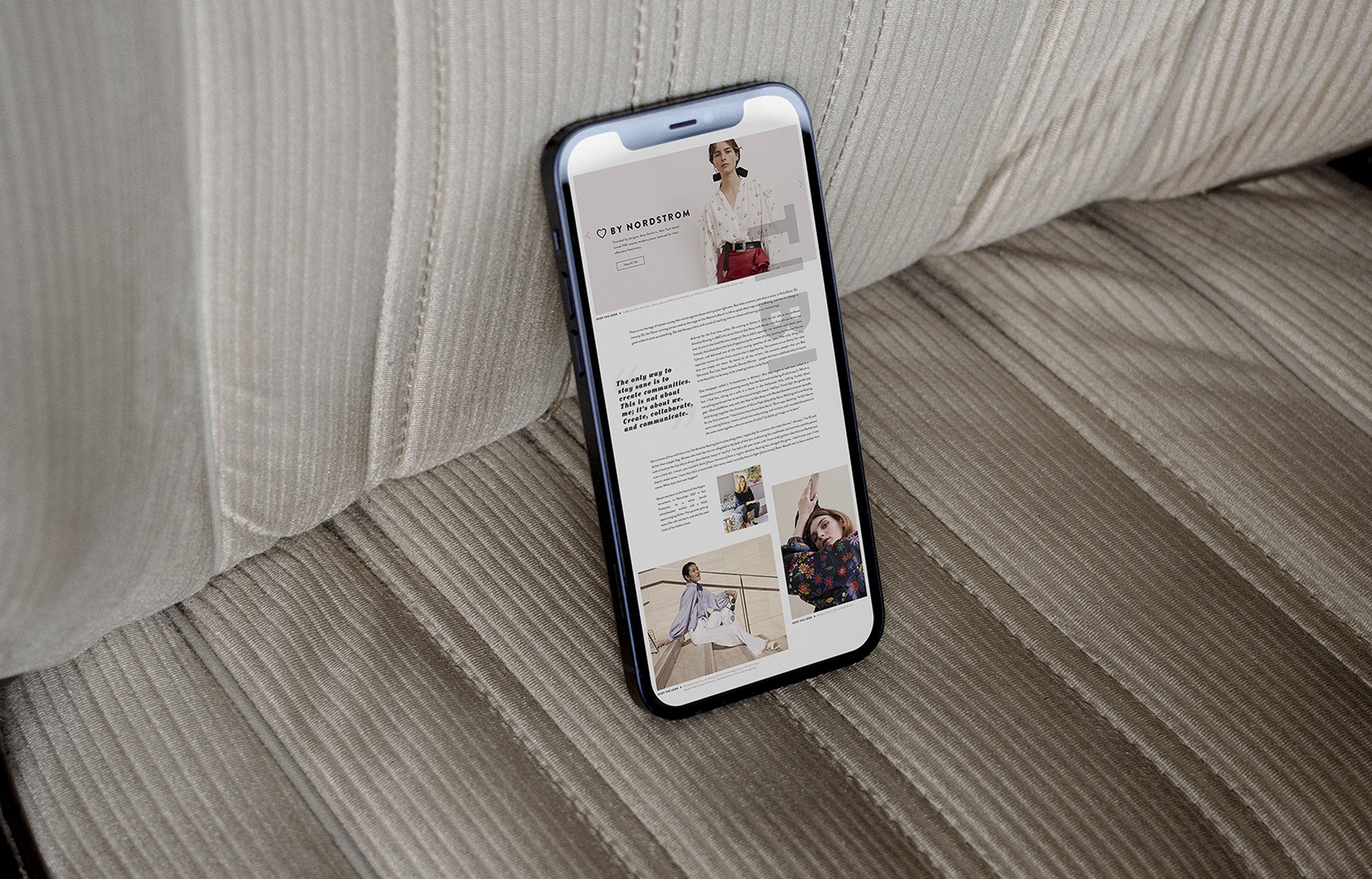 iPhone showing By Nordstrom landing page laid on corduroy couch