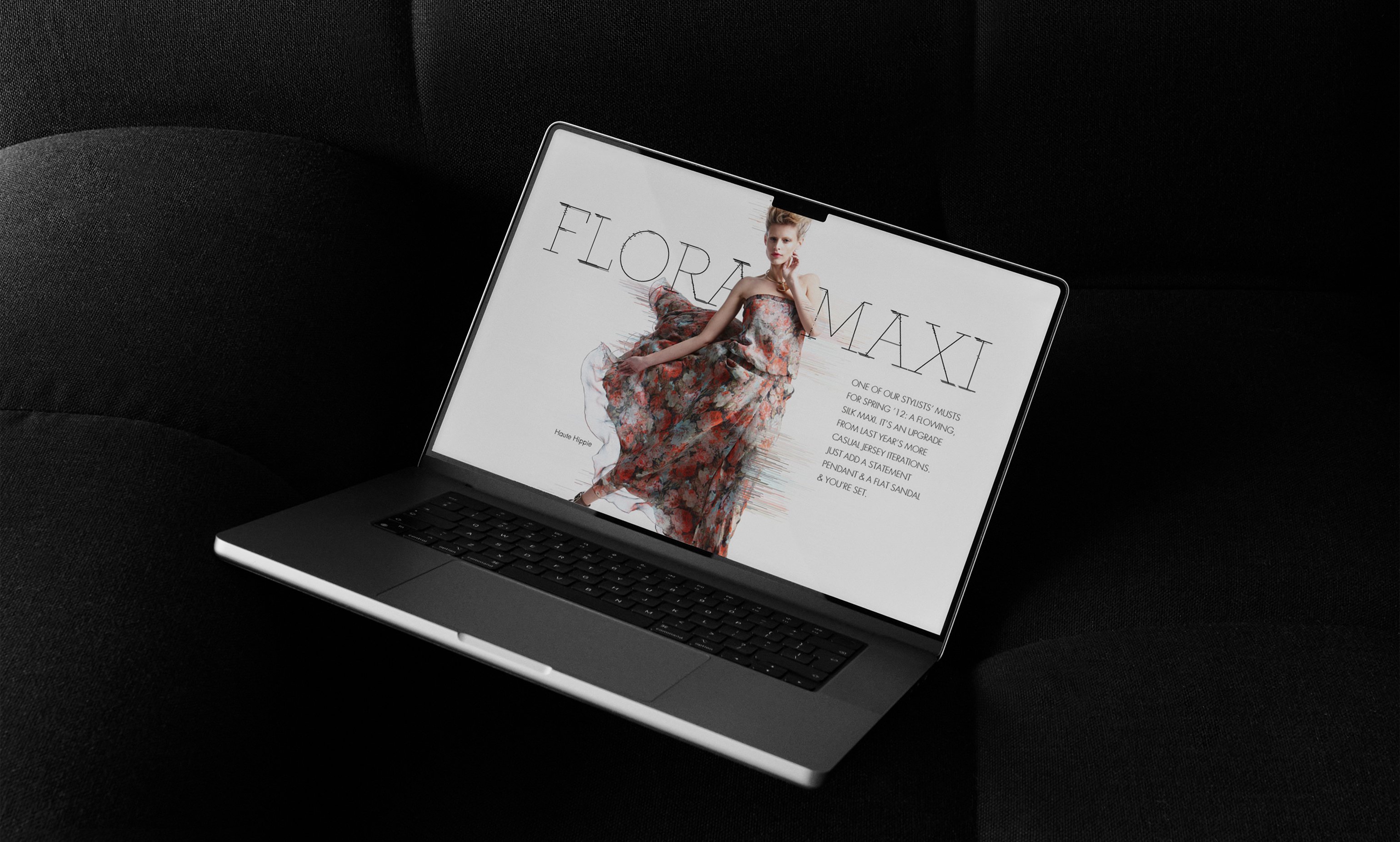 Neiman Marcus InSite Flora Maxi story on laptop resting on black couch
